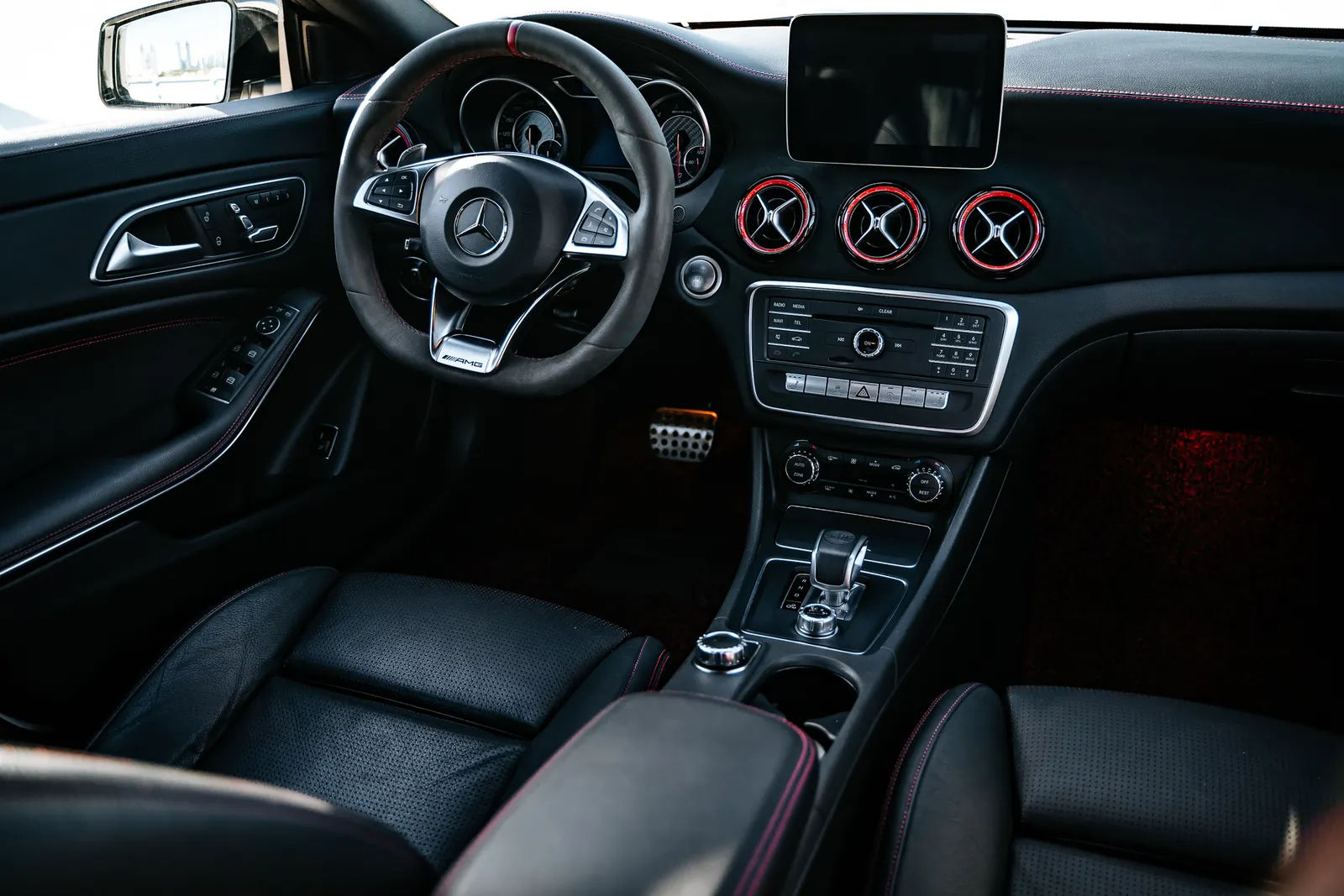 A black vehicle interior with clean seats and dashboard