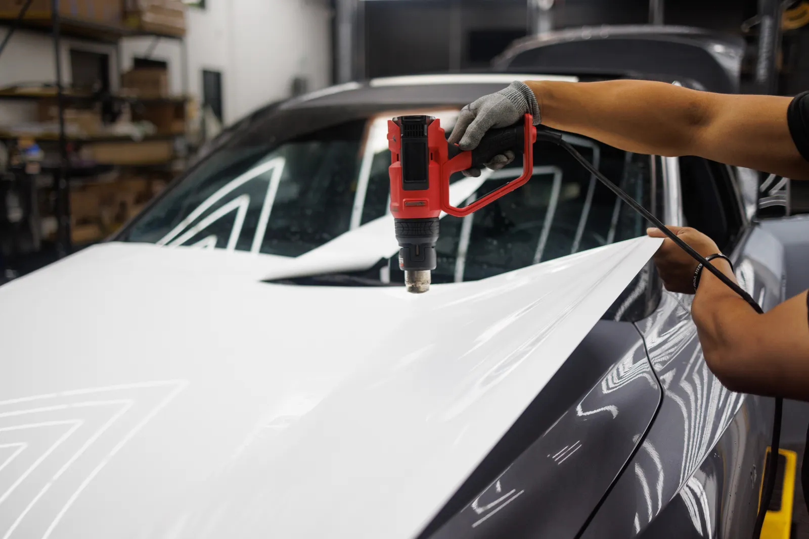 A heat gun being used during automotive vinyl installation