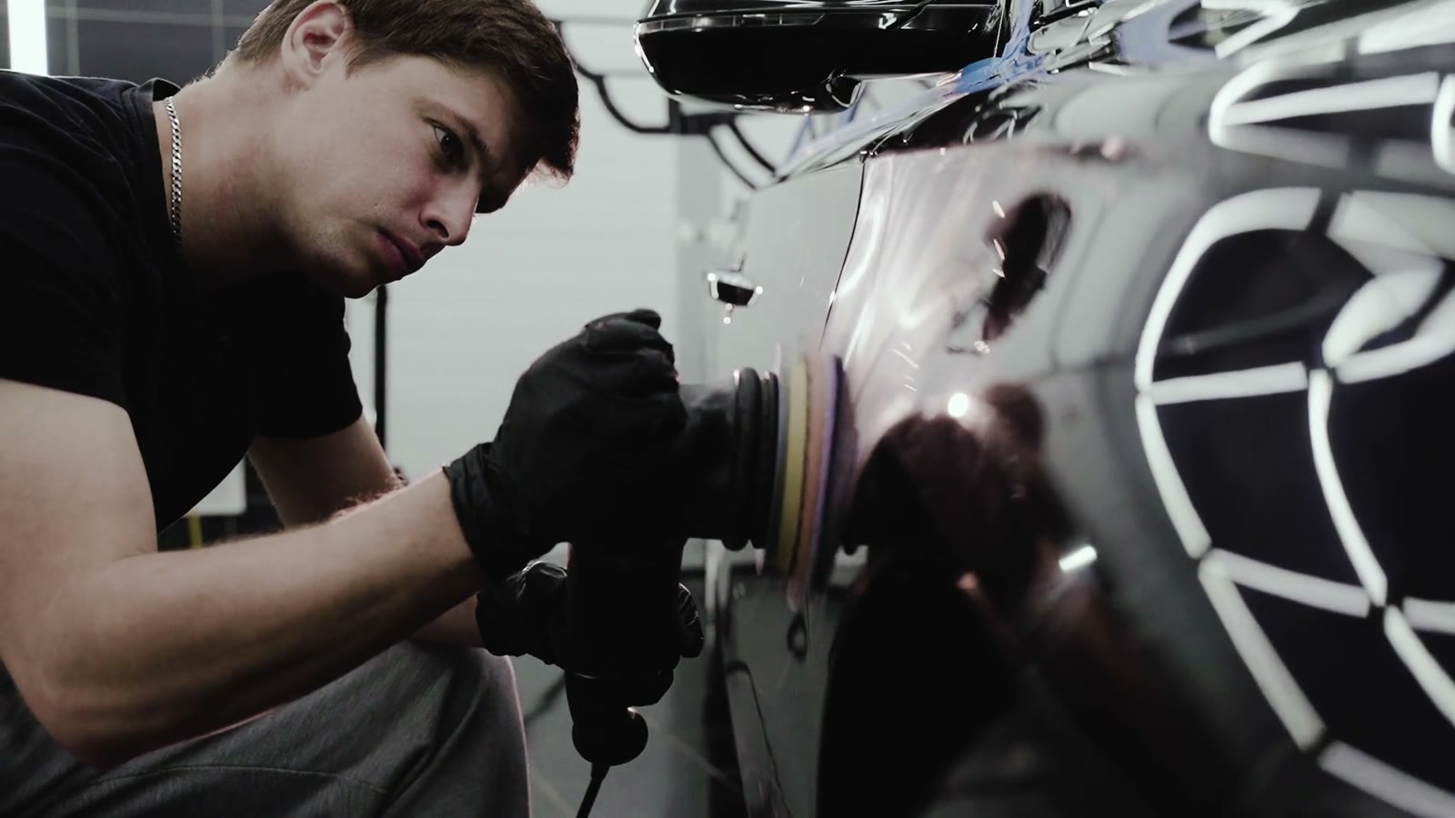 Machine polishing a black vehicle panel